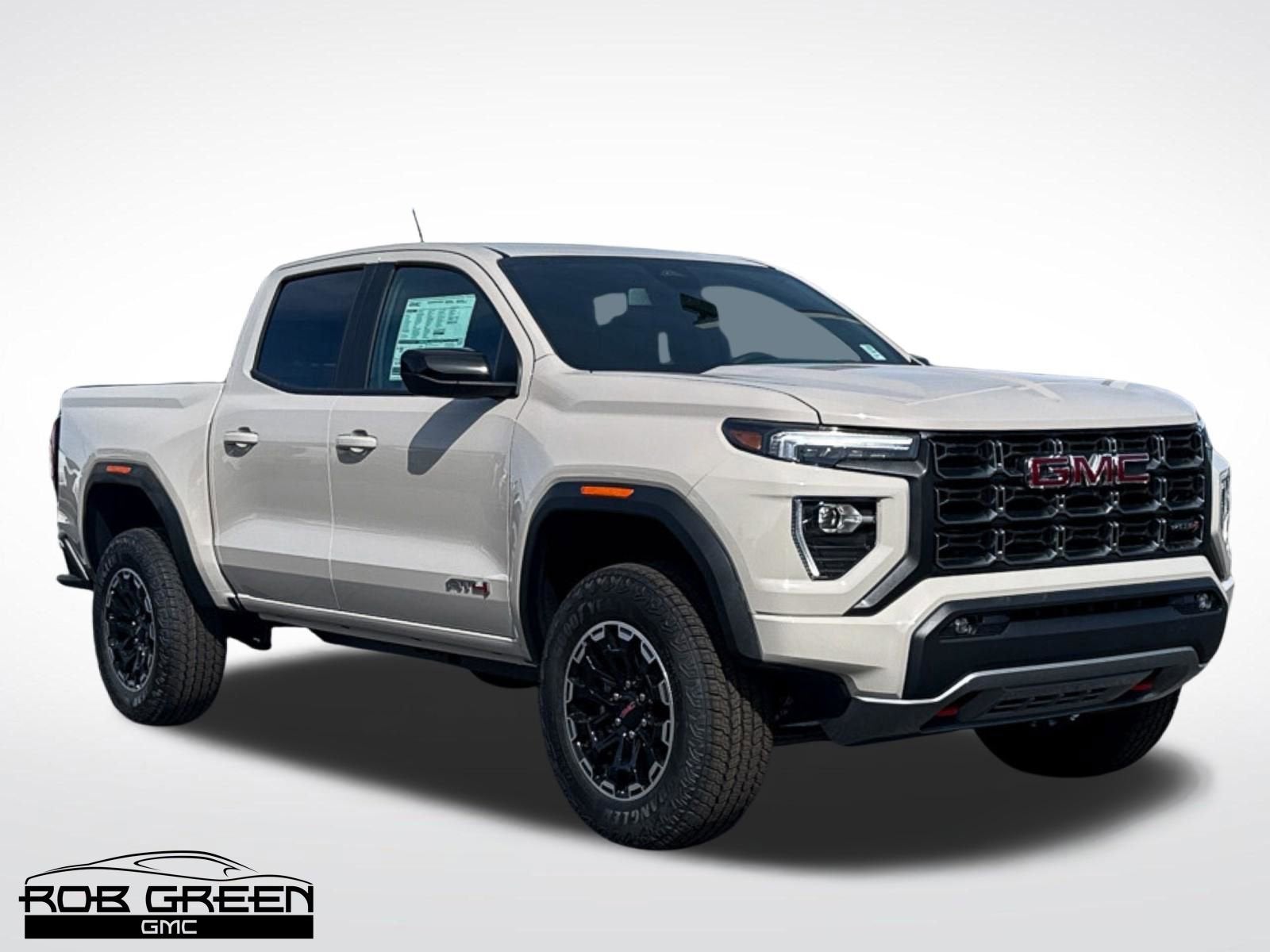 2026 GMC Canyon AT4 in Coastal Dune — front three-quarter view